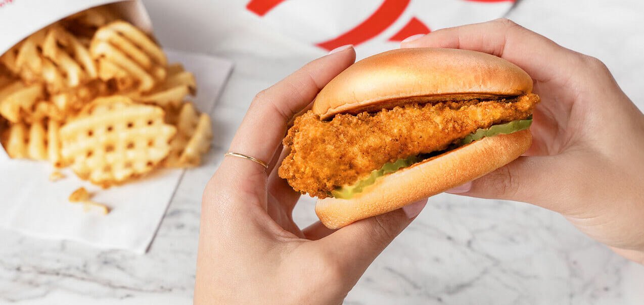 Female hands holding a Chick-fil-A® Chicken Sandwich